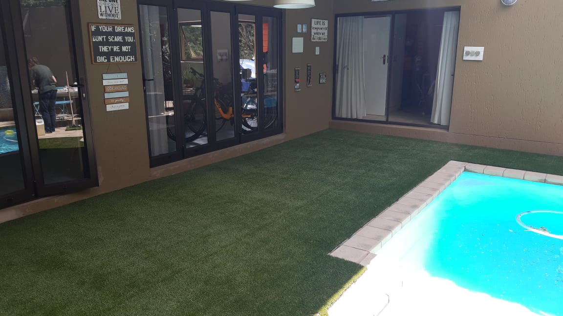 Artificial grass around swimming pool area